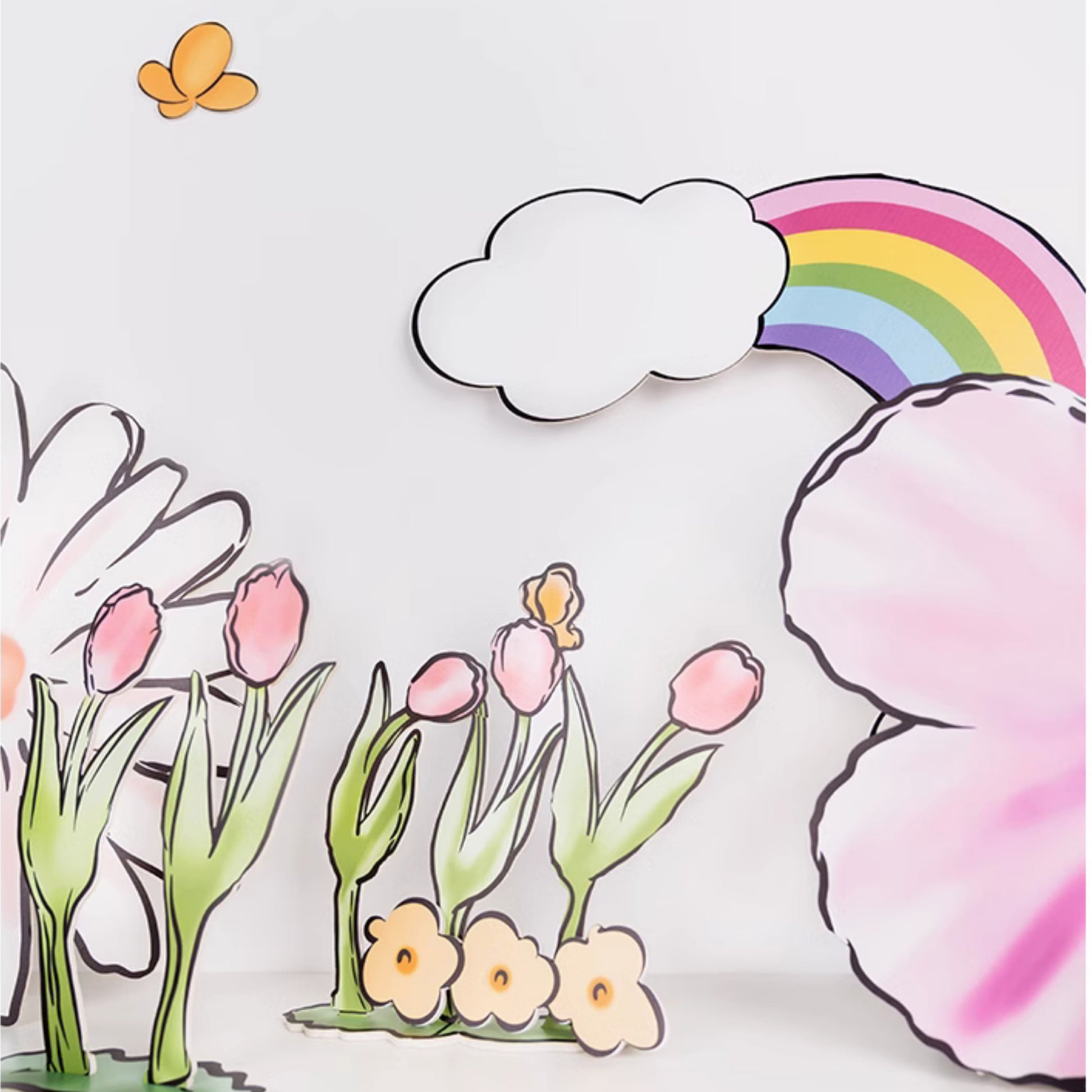 Hand-drawn style image featuring pink flowers and tulips in the foreground. A butterfly hovers above the tulips. In the background, a rainbow arches over a cloud, and more flowers. The overall theme is cheerful and colorful, evoking a spring or summer scene—perfect for Eanjia's Rainbow Tulip Garden Cutouts | 16pc Watercolor Daisy & Squirrel Decor | Baby Shower & Birthday Props for standee cutouts for party decor.